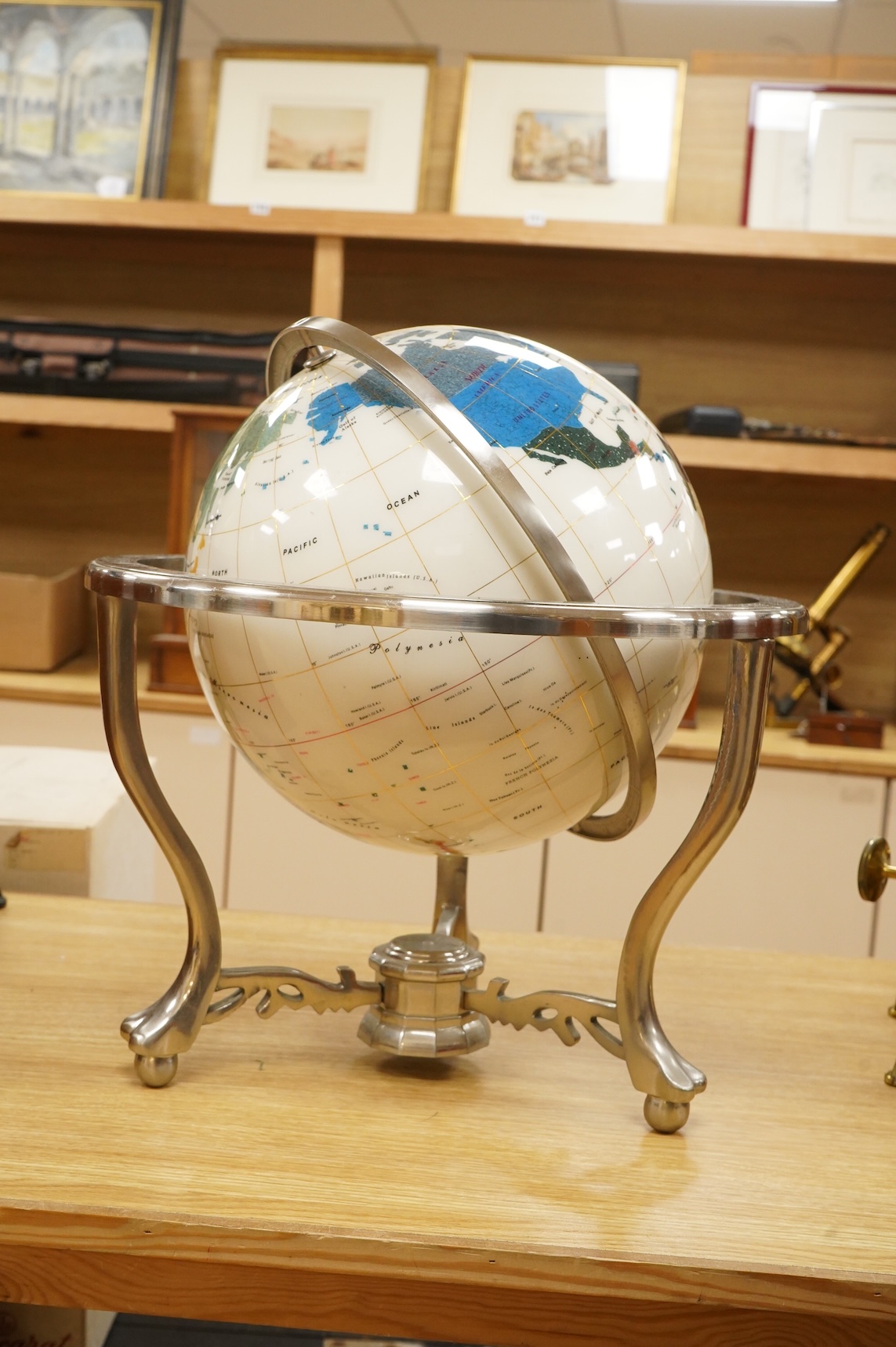 A modern globe on a chromed stand with inset minerals, 12 inch diameter globe
